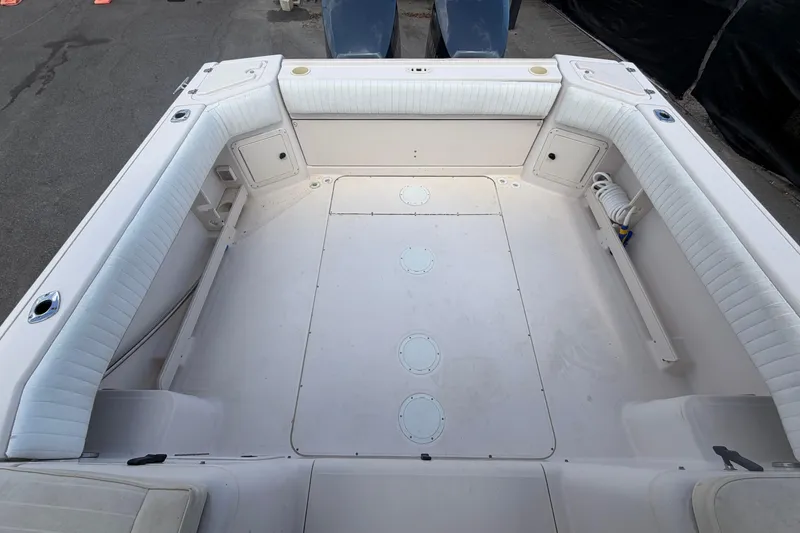 Slide: The Image of Spacious deck of 2000 Grady-White Express 265 boat with cushioned seating. - 96