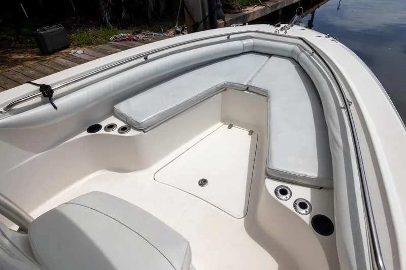 Slide: The Image of 2007 Boston Whaler 270 Outrage boat interior with cushioned seating and cup holders. - 12