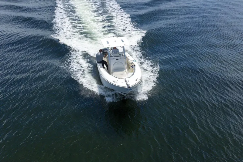 Slide: The Image of 2007 Boston Whaler 270 Outrage cruising on open water, creating a wake. - 14