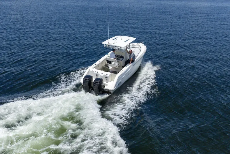 Slide: The Image of 2007 Boston Whaler 270 Outrage cruising on open water, rear view. - 15