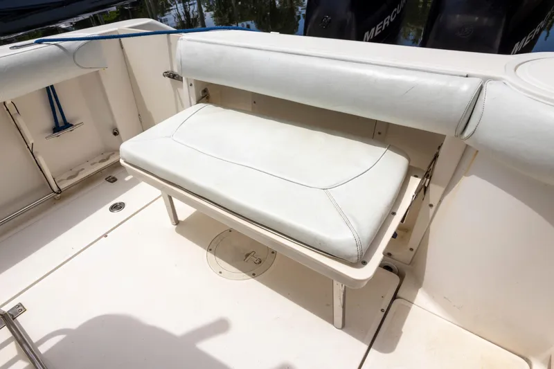 Slide: The Image of 2007 Boston Whaler 270 Outrage boat with foldable white bench seat and storage compartment. - 5