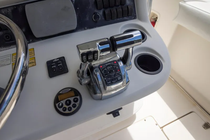 Slide: The Image of Control panel of a 2007 Boston Whaler 270 Outrage boat, featuring throttle and switches. - 7
