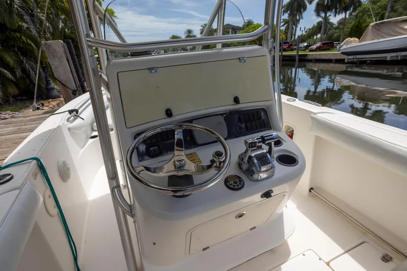 Slide: The Image of 2007 Boston Whaler 270 Outrage boat console with steering wheel and controls. - 9