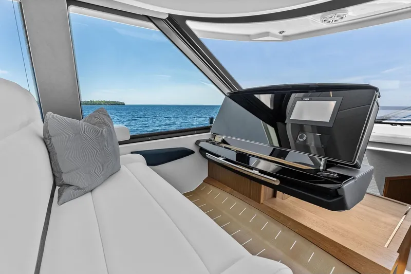 Slide: The Image of Luxurious interior of 2025 Tiara Yachts EX 60 with ocean view and modern dashboard. - 59