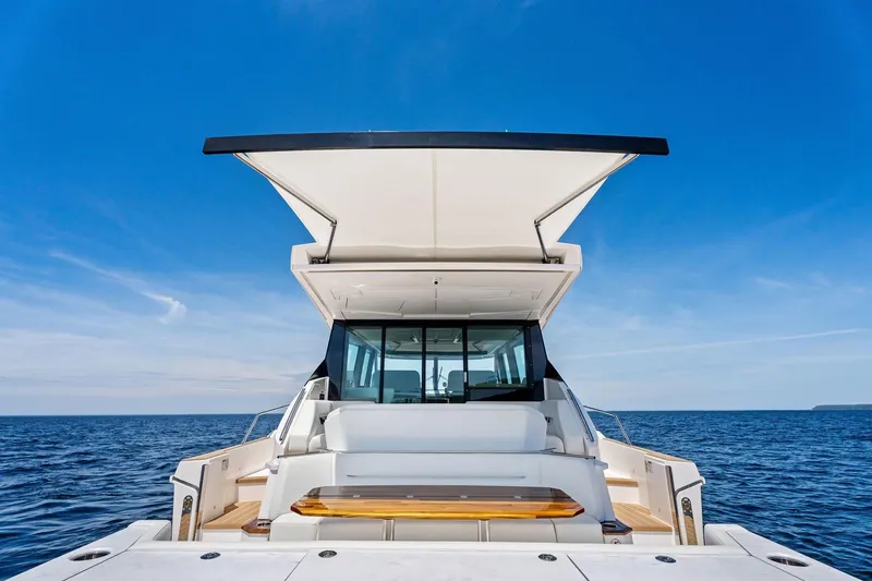 Slide: The Image of 2025 Tiara Yachts EX 60 luxury yacht on open sea under clear blue sky. - 43