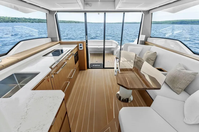 Slide: The Image of Luxurious interior of 2025 Tiara Yachts EX 60 with modern kitchen and seating area. - 74