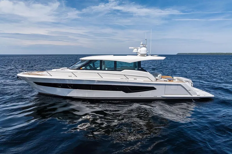 Slide: The Image of 2025 Tiara Yachts EX 60 luxury yacht cruising on open water under a clear sky. - 81