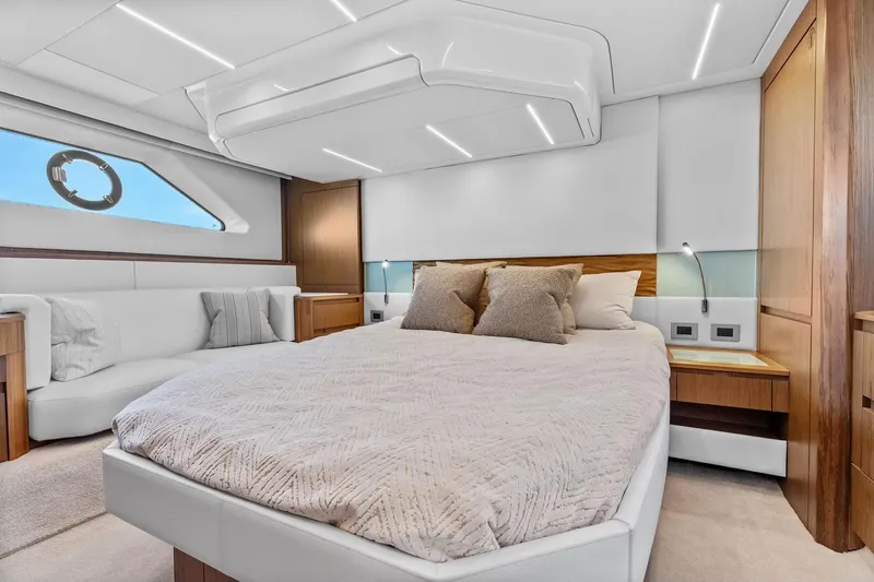Slide: The Image of Luxurious bedroom interior of 2025 Tiara Yachts EX 60, featuring modern design and cozy bedding. - 44
