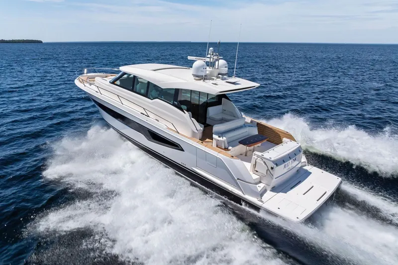 Slide: The Image of 2025 Tiara Yachts EX 60 cruising on open water, showcasing sleek design and luxury features. - 67