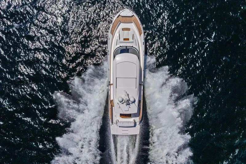 Slide: The Image of Aerial view of 2025 Tiara Yachts EX 60 cruising on open water. - 69