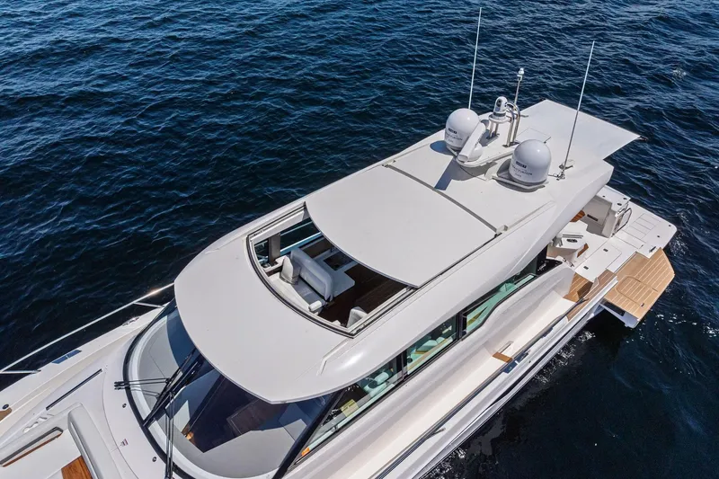 Slide: The Image of 2025 Tiara Yachts EX 60 luxury yacht cruising on open water, aerial view. - 58