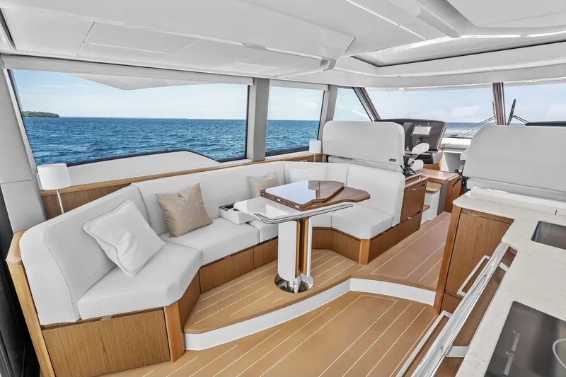 Slide: The Image of Luxurious interior of 2025 Tiara Yachts EX 60 with elegant seating and ocean view. - 73