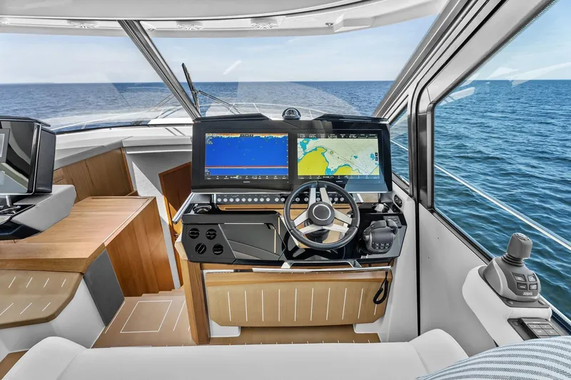 Slide: The Image of 2025 Tiara Yachts EX 60 helm with advanced navigation displays and ocean view. - 56