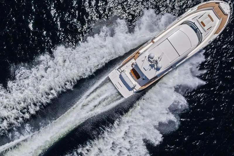Slide: The Image of Aerial view of 2025 Tiara Yachts EX 60 cruising on open water. - 70