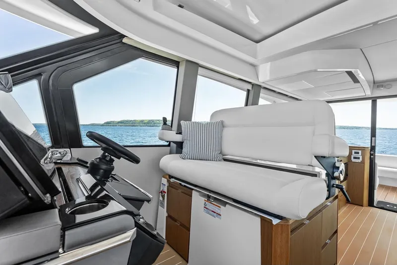 Slide: The Image of Interior of 2025 Tiara Yachts EX 60, featuring modern helm and seating with ocean view. - 57