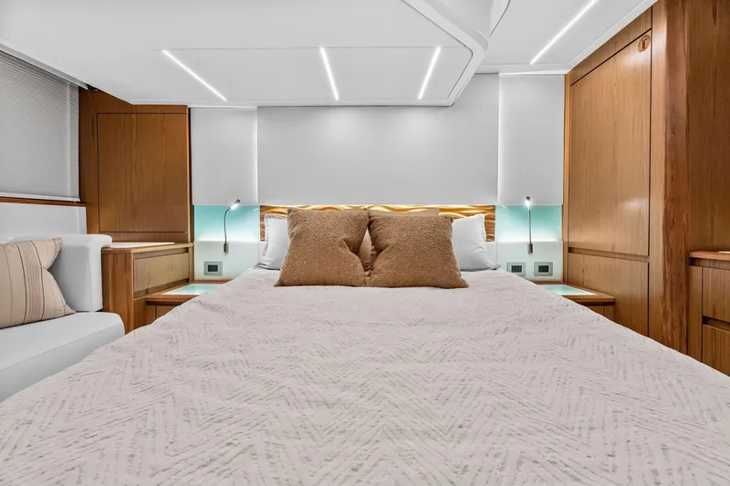 Slide: The Image of Luxurious bedroom interior of 2025 Tiara Yachts EX 60, featuring elegant wood finishes and modern lighting. - 47