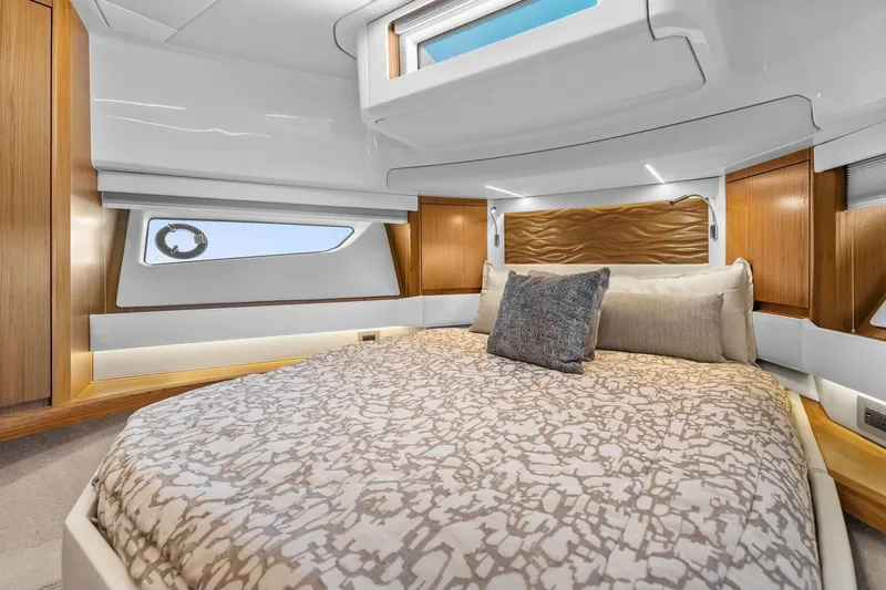 Slide: The Image of Luxurious bedroom interior of 2025 Tiara Yachts EX 60, featuring elegant wood accents and modern design. - 52