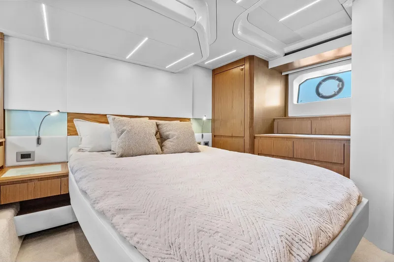 Slide: The Image of Luxurious bedroom interior of 2025 Tiara Yachts EX 60, featuring modern design and elegant wood finishes. - 46