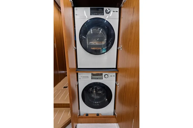 Slide: The Image of Stacked washer and dryer in 2025 Tiara Yachts EX 60 interior. - 48