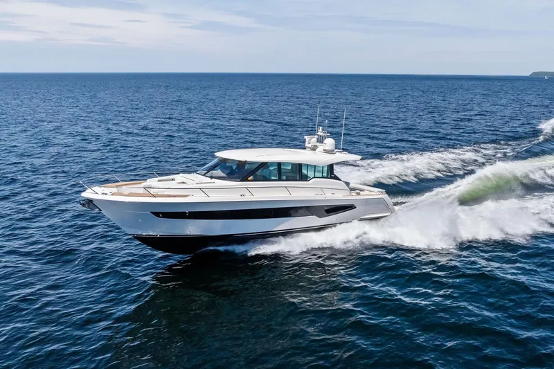 Slide: The Image of 2025 Tiara Yachts EX 60 cruising on open sea, showcasing sleek design and performance. - 65