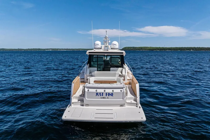 Slide: The Image of 2025 Tiara Yachts EX 60 on open water, rear view, sunny day. - 80