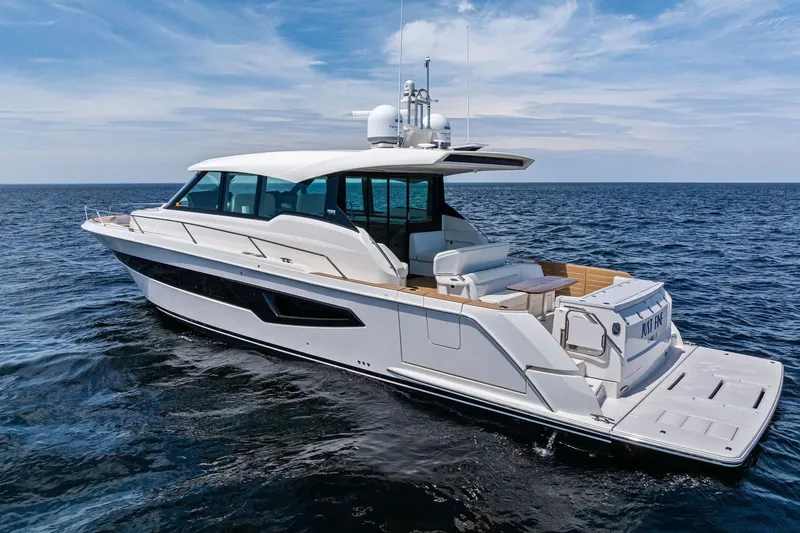 Slide: The Image of 2025 Tiara Yachts EX 60 luxury yacht cruising on open sea under clear skies. - 82