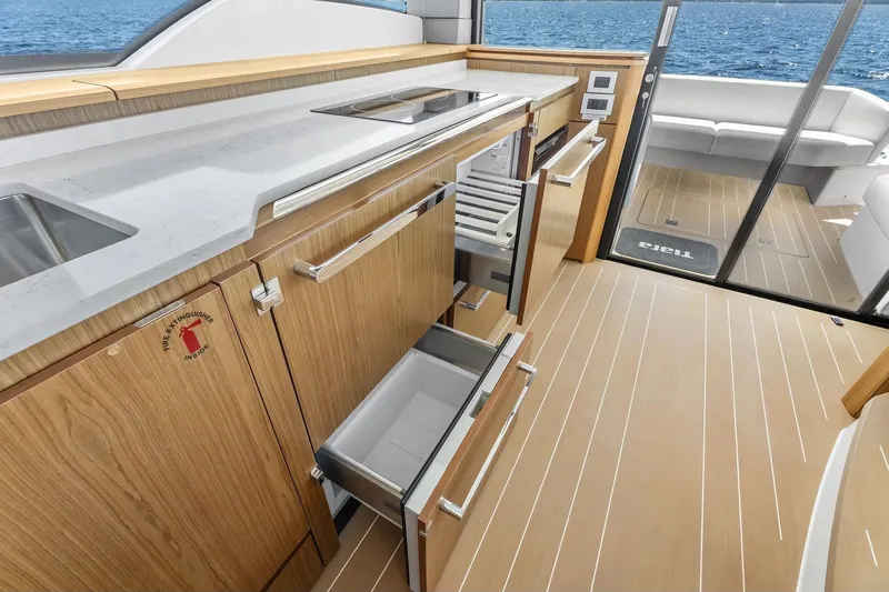 Slide: The Image of Luxurious 2025 Tiara Yachts EX 60 interior kitchen with modern cabinetry and ocean view. - 66