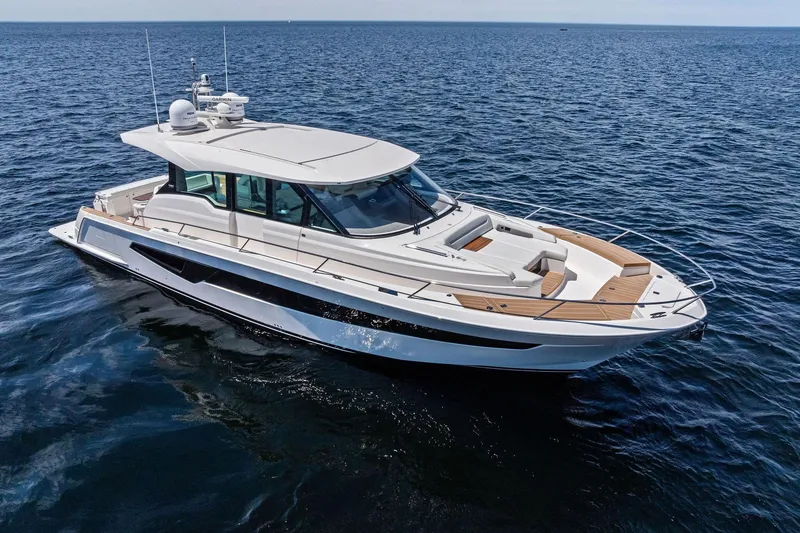 Slide: The Image of 2025 Tiara Yachts EX 60 luxury yacht cruising on open water. - 78