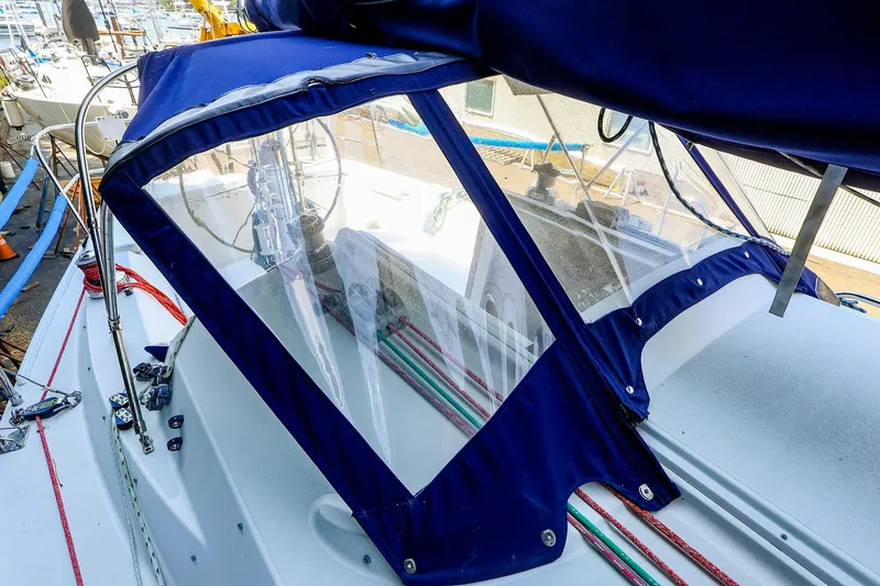 Slide: The Image of 2001 J Boats J/32 sailboat cockpit with blue canvas cover and visible rigging. - 12
