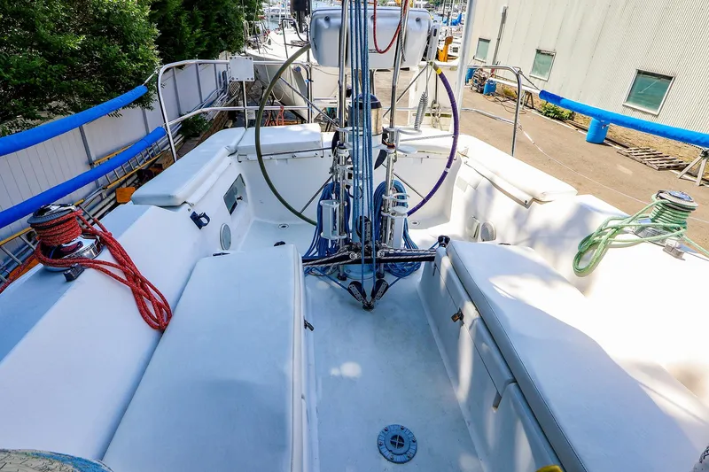 Slide: The Image of 2001 J Boats J/32 sailboat cockpit with steering wheel and rigging, docked at marina. - 5