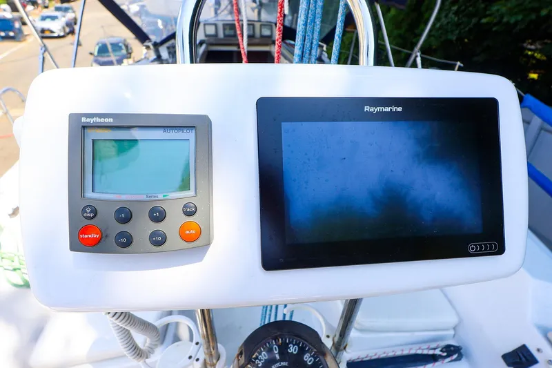 Slide: The Image of 2001 J Boats J/32 cockpit with Raytheon autopilot and Raymarine navigation display. - 7
