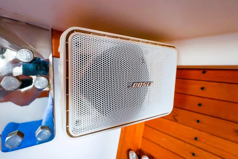 Slide: The Image of Bose speaker mounted on a 2001 J Boats J/32, with wooden paneling and metal bolts. - 40