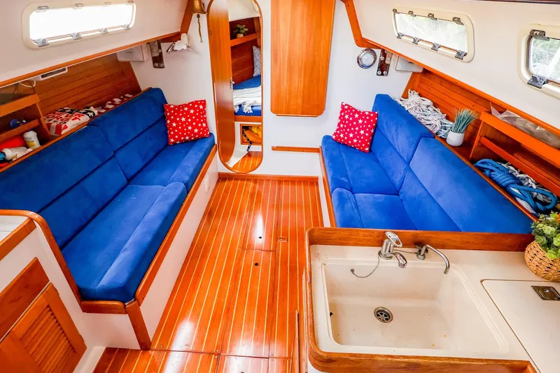 Slide: The Image of Interior of 2001 J Boats J/32 sailboat with blue seating and wooden finishes. - 25