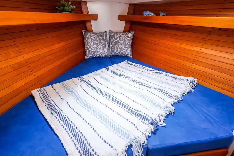 Slide: The Image of Cozy cabin interior of 2001 J Boats J/32 with blue cushions and striped blanket. - 41