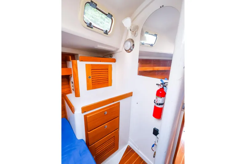 Slide: The Image of Interior of 2001 J Boats J/32 sailboat with wooden cabinets and fire extinguisher. - 38