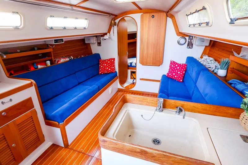 Slide: The Image of Interior of 2001 J Boats J/32 sailboat with blue seating and wooden accents. - 26