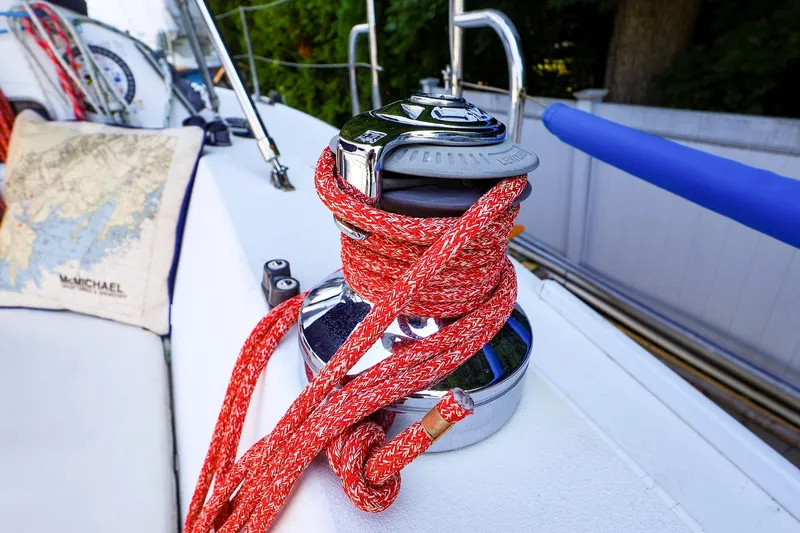 Slide: The Image of Red rope wrapped around a winch on a 2001 J Boats J/32 sailboat deck. - 14