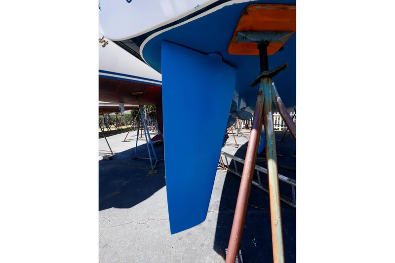 Slide: The Image of 2001 J Boats J/32 sailboat keel on stands, blue hull, outdoor setting. - 4