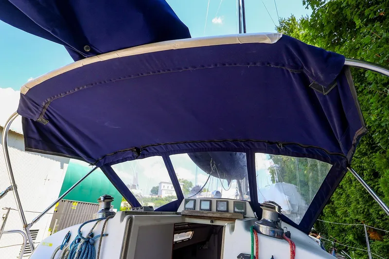 Slide: The Image of 2001 J Boats J/32 sailboat cockpit with blue canvas cover and ropes. - 11