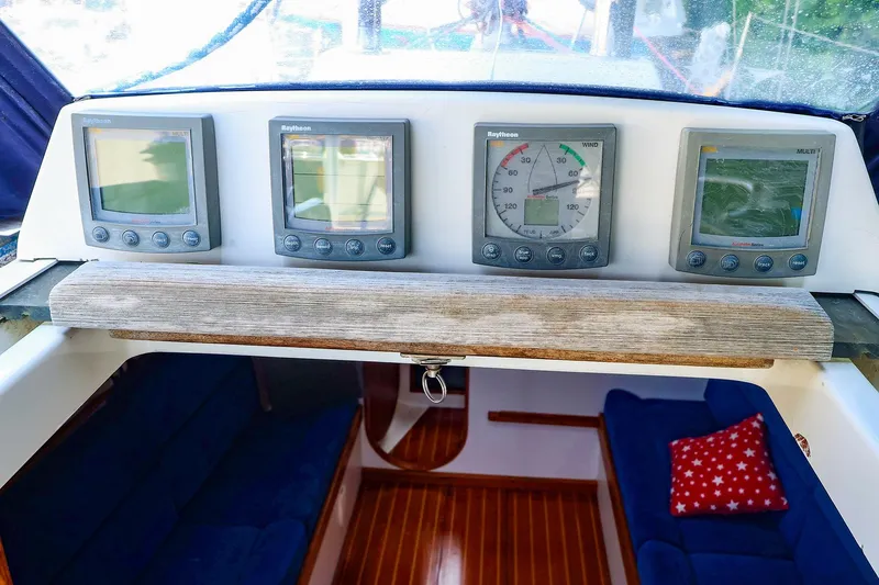 Slide: The Image of 2001 J Boats J/32 cockpit with Raytheon navigation instruments and cozy interior seating. - 10