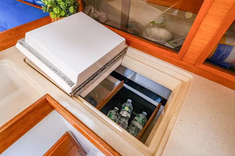 Slide: The Image of Interior of 2001 J Boats J/32 showing a built-in cooler with water bottles. - 33