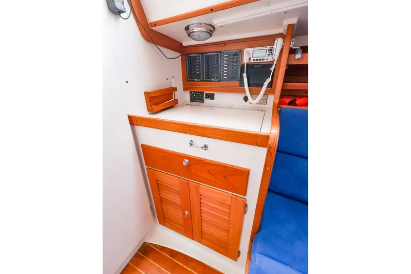 Slide: The Image of 2001 J Boats J/32 interior with control panel, wooden cabinetry, and blue seating. - 35
