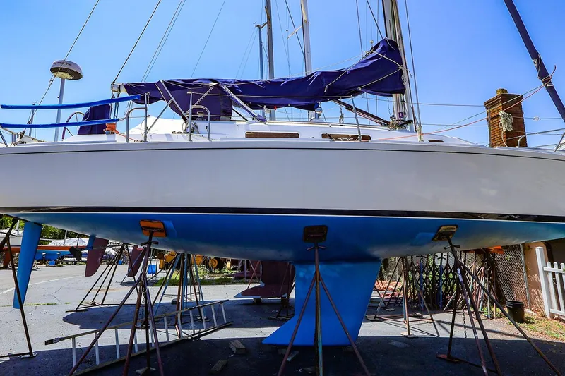 Slide: The Image of 2001 J Boats J/32 sailboat on stands, undergoing maintenance in a boatyard. - 1