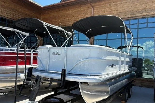 The Image of 2026 Sun Tracker Party Barge 20 DLX pontoon boat displayed outdoors. - 0