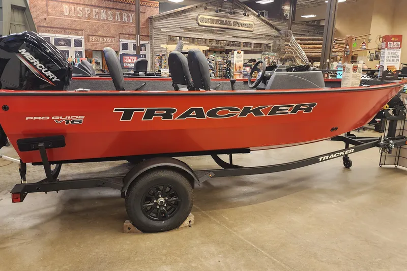 The Image of 2026 Tracker Pro Guide V-16 SC boat displayed indoors on a trailer. - 0