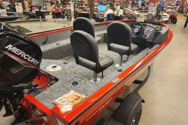 Slide: The Image of 2026 Tracker Pro Guide V-16 SC boat with Mercury engine in showroom. - 44