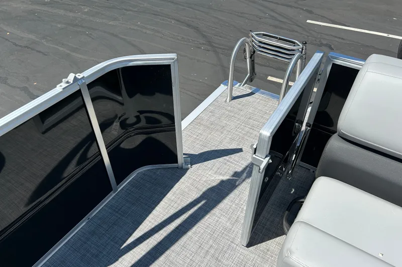 Slide: The Image of 2026 Sun Tracker Party Barge 20 DLX pontoon boat deck with open gate and seating. - 15