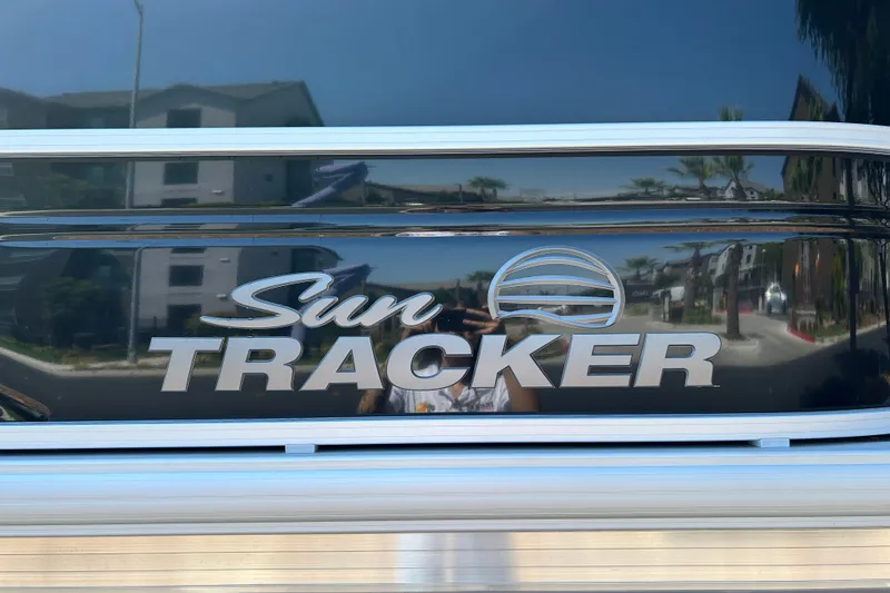 Slide: The Image of Sun Tracker Party Barge 20 DLX 2026 logo on reflective surface. - 23