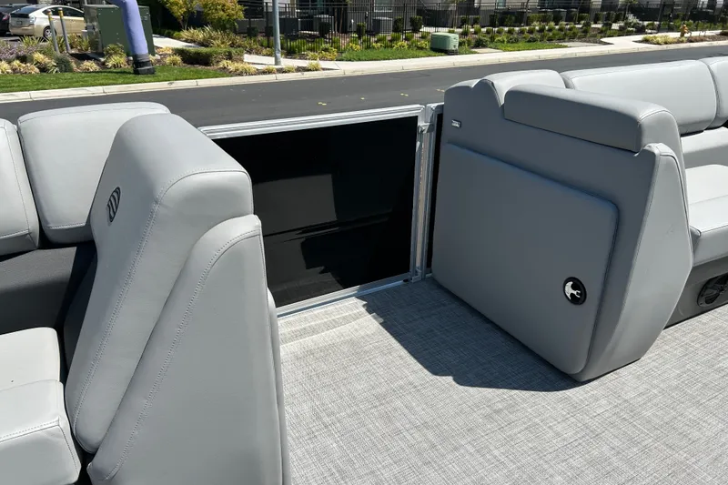 Slide: The Image of 2026 Sun Tracker Party Barge 20 DLX interior with gray seating and flooring. - 19