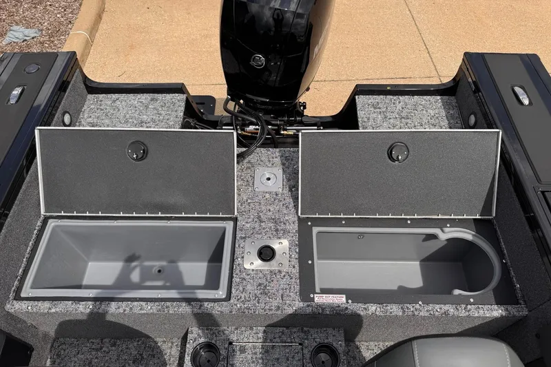 Slide: The Image of 2026 Tracker Targa V-19 WT boat interior with open storage compartments and motor. - 11